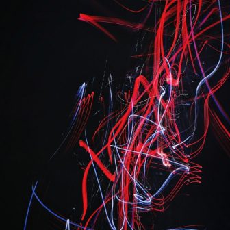 Abstract red blue on black glass splashback